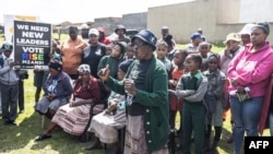 FILE—An elderly woman gestures as she gather with supporters of the South African political party Rise Mzanzi during a community meeting in Eden Park, Alberton, on April 12, 2024.