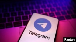 FILE - The Telegram app logo is seen on a phone against the backdrop of a keyboard in an illustration photo taken Aug. 27, 2024.