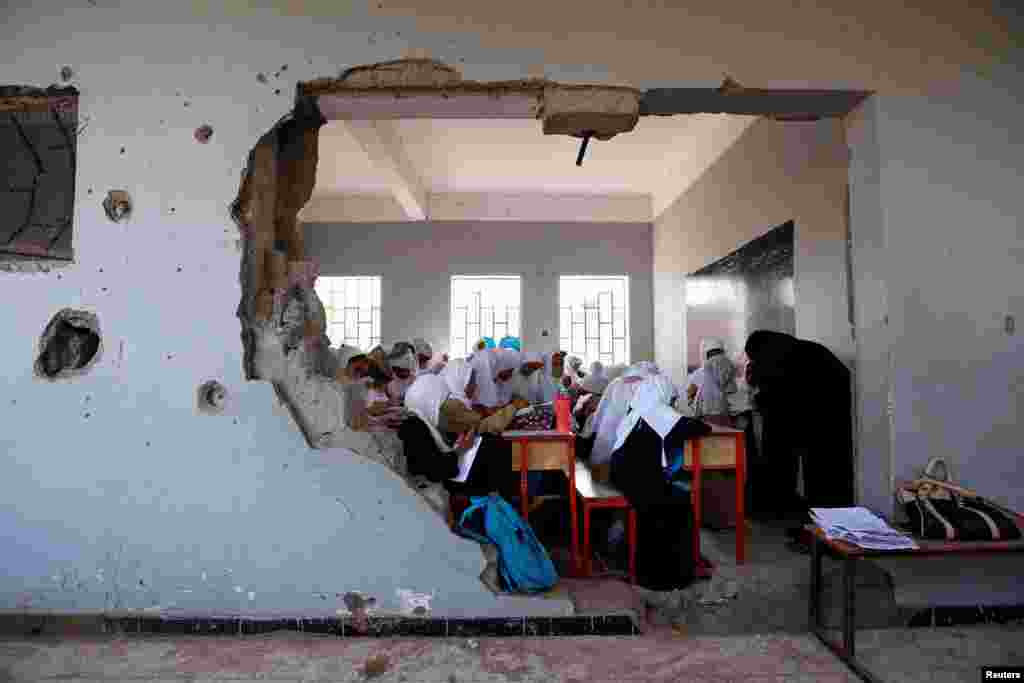 Girls attend a class at their school, damaged by a recent Saudi-led airstrike, in the Red Sea port city of Hodeidah, Yemen, Oct. 24, 2017.