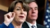 Sen. Amy Klobuchar, D-Minn., left, and Sen. Mark Warner, D-Va., speak about online political ads and preventing foreign interference in U.S. elections, during a news conference on Capitol Hill in Washington, Oct. 19, 2017. 