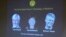 Images of the winners of the 2014 Nobel Prize for Medicine, U.S.-British scientist John O'Keefe and Norwegian husband and wife Edvard Moser and May-Britt Moser are projected on a screen during the announcement in Stockholm Monday Oct. 6, 2014.