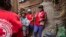 Red Cross volunteers talk to villagers about the plague outbreak, 30 miles west of Antananarivo, Madagascar, Oct. 16, 2017. 