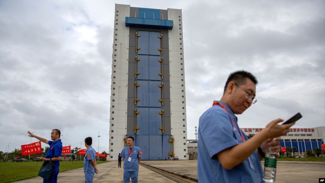 Workers gather near a building at the Wenchang Space Launch Site in Wenchang in southern China's Hainan province, Nov. 23, 2020. 