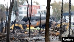 An emergency worker stands on the site of the train wreck in Lac Megantic, Quebec, Canada, July 16, 2013. 