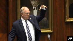 Arizona Republican state Rep. Don Shooter drops his mic after voting no on a resolution expelling him from the Arizona House for a pattern of sexual harassment in Phoenix, Arizona, Feb. 1, 2018.