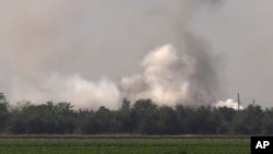 In this image provided by Russian television on Tuesday, Aug. 16, 2022, smoke rises over the site of explosion at an ammunition storage of Russian army near the village of Mayskoye, Crimea in the second suspected Ukrainian attack on the peninsula in just over a week