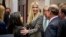 In this Nov. 14, 2018, photo, Ivanka Trump, the daughter of President Donald Trump, center, greets guests after President Donald Trump spoke about prison reform in the Roosevelt Room of the White House in Washington.