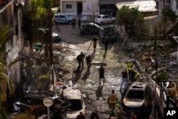 Israeli information    forces analyse   the tract  deed  by a rocket fired from Lebanon, successful  Kiryat Bialik, bluish   Israel, connected  Sept. 22, 2024.