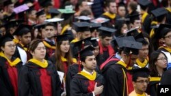 FILE - New graduates participate in a Rutgers University graduation ceremony in Piscataway Township, N.J., Sunday, May 13, 2018. (AP Photo/Seth Wenig)