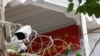 A propaganda banner and a security camera are placed on the walls of a mosque in the Old City in Kashgar, Xinjiang Uighur Autonomous Region, China, Sept. 6, 2018. 