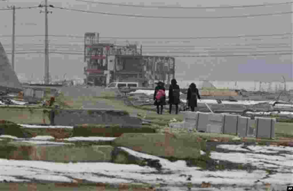 Junior high school students walk home after school in the area devastated by the March 11, 2011 earthquake and tsunami, in Minamisanriku, Miyagi Prefecture, Japan, Friday, March 2, 2012. (AP Photo/Shizuo Kambayashi)