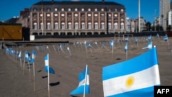 People in Mar del Plata, Argentina, planted 504 small Argentine flags on Bristol Beach, seen here Oct. 8, 2020, to honor coronavirus victims.