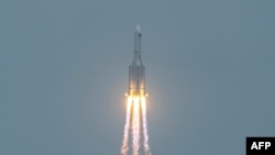 FILE - A Long March 5B rocket, carrying China's Tianhe space station core module, lifts off from the Wenchang Space Launch Center in southern China's Hainan province on April 29, 2021. 