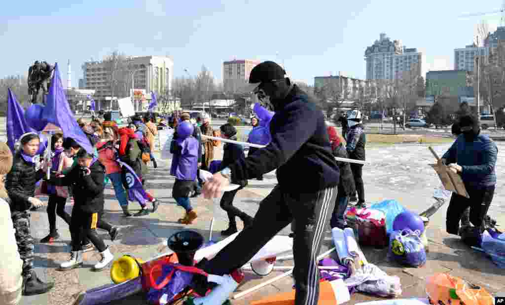 Masked Kyrgyz nationalists attack women&#39;s rights activists during the celebration of the International Women&#39;s Day at Victory Square in Bishkek, Kyrgyzstan.