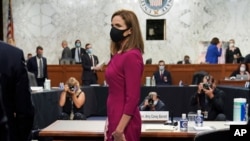 Supreme Court nominee Amy Coney Barrett stands during a break in her Senate Judiciary Committee confirmation hearing before the Senate Judiciary Committee on Capitol Hill in Washington, Oct. 12, 2020.