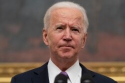 President Joe Biden speaks about the coronavirus in the State Dinning Room of the White House, Jan. 21, 2021, in Washington.