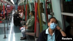 Habitantes de Hong Kong viajan en tren con mascarilla para evitar contagios, el 4 de febrero de 2020.