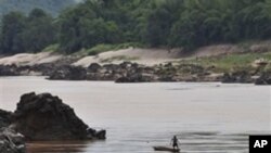 A fisherman works near the site of the proposed Xayaburi Dam in Paksey, northern Laos. (File)