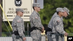 Soldiers stand guard on the driveway leading to the courthouse holding the the court martial of Maj. Nidal Malik Hasan in Fort Hood, Texas, August 23, 2013. 