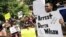 Protestors at the St. Louis County Justice Center call for the arrest of Police Officer Darren Wilson in Clayton, Missouri, Aug. 20, 2014.
