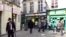 FILE - People walk in the street in the Marais Jewish quarter in Paris.