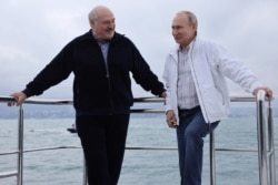 Russian President Vladimir Putin and his Belarusian counterpart Alexander Lukashenko take a boat trip off the Black Sea coast, Russia, May 29, 2021.
