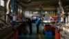 Workers monitor the production line of drip tape fittings at a factory of DAYU Water Group Co. in Jiuquan, Gansu province, China, Oct. 18, 2024.