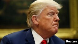 FILE - U.S. President Donald Trump answers questions from the news media in the Roosevelt Room of the White House in Washington, Aug. 29, 2018.