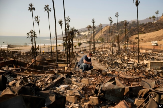 Kevin Marshall looks at his mother's fire-ravaged property in the the Palisades Fire in the Pacific Palisades neighborhood of Los Angeles, Jan. 11, 2025.