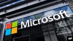 This May 6, 2021 photo shows a sign for Microsoft offices in New York. (AP Photo/Mark Lennihan)
