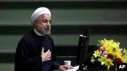 FILE - Iranian President Hasan Rouhani speaks during a debate on a proposed Cabinet at the parliament, in Tehran, Iran.