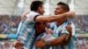 Argentina's Lionel Messi (L-R) celebrates with teammates Angel Di Maria and Marcos Rojo after scoring against Nigeria during their 2014 World Cup Group F soccer match at the Beira Rio stadium in Porto Alegre, June 25, 2014. 