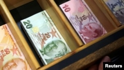 Turkish lira banknotes are pictured at a currency exchange office in Istanbul, Turkey, Aug. 13, 2018. 