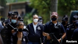 FILE PHOTO: Attorney General Rodolfo Delgado arrives at a news conference at the site where authorities are excavating a clandestine cemetery discovered at the house of a former police officer in Chalchuapa, El Salvador, May 21, 2021.
