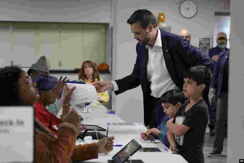 Republican vice presidential nominee Sen. JD Vance, R-Ohio, with his children, arrives to vote at the St. Anthony of Padua Maronite Catholic Church, Nov. 5, 2024, in Cincinnati.