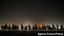 Soldiers participate in a rehearsal for the upcoming Republic Day Parade in New Delhi, India.