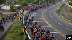 Central American migrants, part of the caravan hoping to reach the U.S. border, walk in Frontera Hidalgo, Mexico, April 12, 2019.