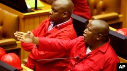 File - South African Economic Freedom Fighters leader Julius Malema (Right) gestures during a session in Parliament, in Cape Town, South Africa, March 2015.