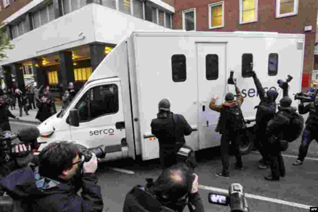 Members of the media gather around a prison van as it leaves the rear entrance of Westminster Magistrates Court in London, Tuesday, Dec. 7, 2010, where WikiLeaks founder Julian Assange was denied bail after appearing on an extradition warrant. Assange sur