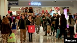 FILE - Shoppers walk inside the Glendale Galleria in Glendale, California.