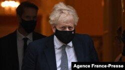 Britain's Prime Minister Boris Johnson leaves from 10 Downing Street in London on Jan. 25, 2022.