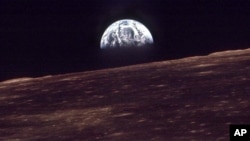 FILE - The Earth shines over the horizon of the Moon in this Dec. 24, 1968, photo shot by the astronauts on Apollo 8. (NASA)