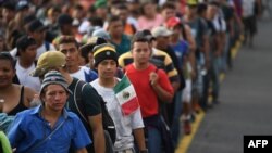 Honduran migrants take part in a caravan heading to the US on the road linking Ciudad Hidalgo and Tapachula, Chiapas state, Mexico, Oct. 21, 2018.