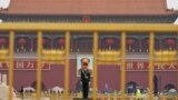 A paramilitary policeman stands guard before a giant portrait of late Chinese Chairman Mao Zedong at the Tiananmen gate, a day before the 19th National Congress of the Communist Party of China begins, in Beijing, China, October 17, 2017. 