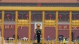 A paramilitary policeman stands guard before a giant portrait of late Chinese Chairman Mao Zedong at the Tiananmen gate, a day before the 19th National Congress of the Communist Party of China begins, in Beijing, China, October 17, 2017. 