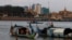 FILE PHOTO - Fishermen row their wooden boats in conjunction with rivers between the Mekong River and Tonle Sap as they catch fish during the fish harvesting season near Phnom Penh, Cambodia, Wednesday, Nov. 28, 2018. (AP Photo/Heng Sinith)