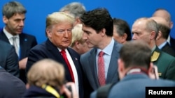 U.S. President Donald Trump talks with Canada's Prime Minister Justin Trudeau during a North Atlantic Treaty Organization Plenary Session at the NATO summit in Watford, near London, Britain, Dec. 4, 2019.
