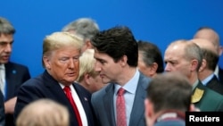 U.S. President Donald Trump talks with Canada's Prime Minister Justin Trudeau during a North Atlantic Treaty Organization Plenary Session at the NATO summit in Watford, near London, Britain, Dec. 4, 2019.