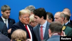 U.S. President Donald Trump talks with Canada's Prime Minister Justin Trudeau during a North Atlantic Treaty Organization Plenary Session at the NATO summit in Watford, near London, Britain, Dec. 4, 2019.