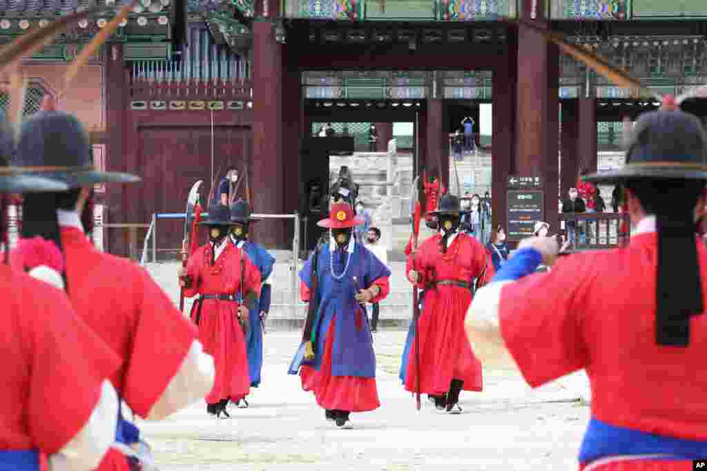 Imperial guards wearing face masks are seen outside the Gyeongbok Palace in Seoul, South Korea.